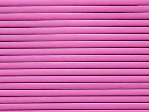 Horizontal pink blinds or slats cover the entire frame, creating a pattern of alternating light and shadow.