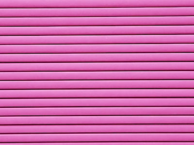 Horizontal pink blinds or slats cover the entire frame, creating a pattern of alternating light and shadow.