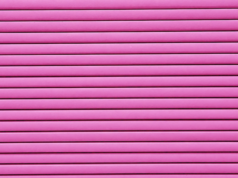 a close up of a bright pink wall