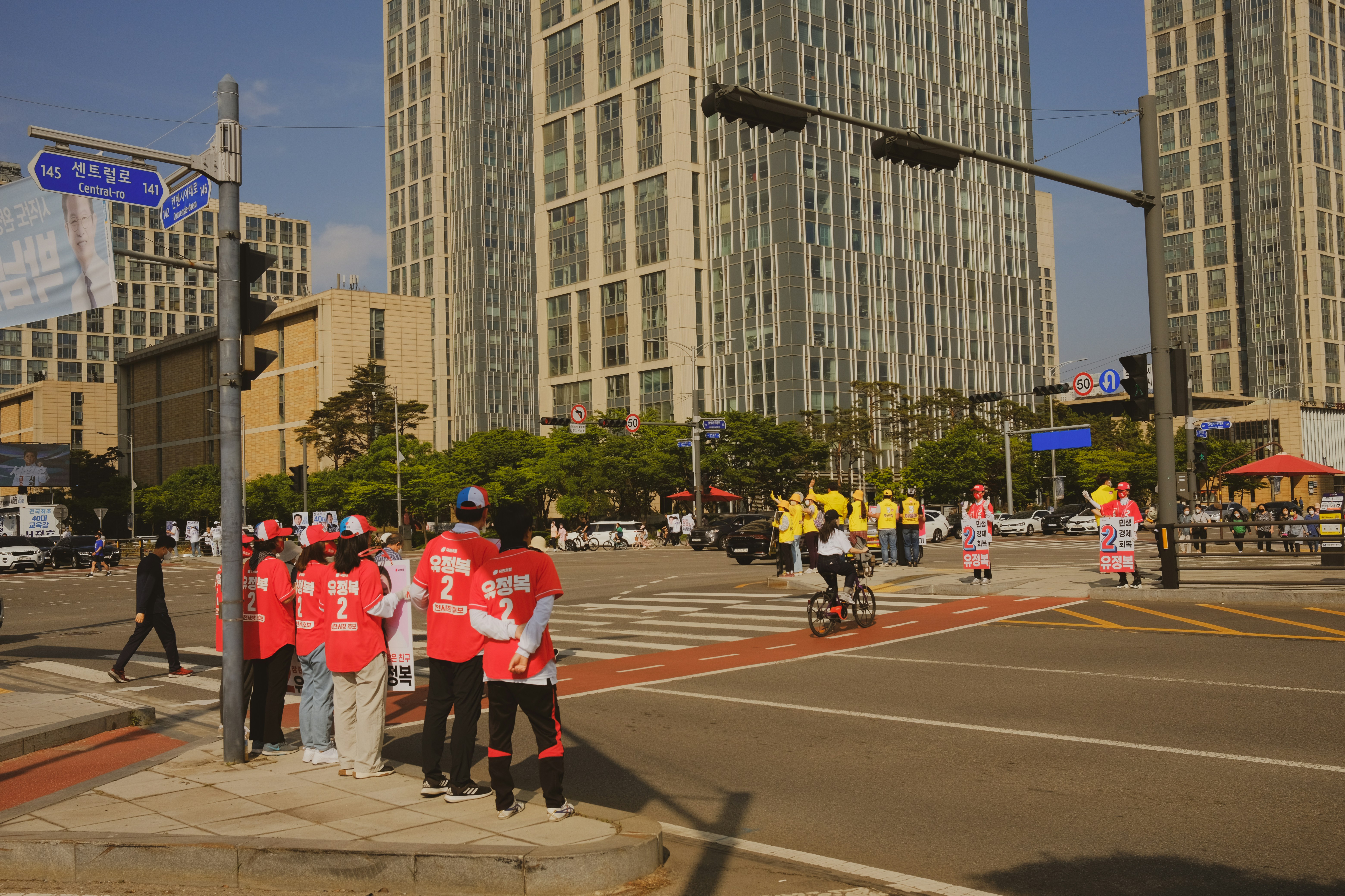 a group of people standing on the side of a road
