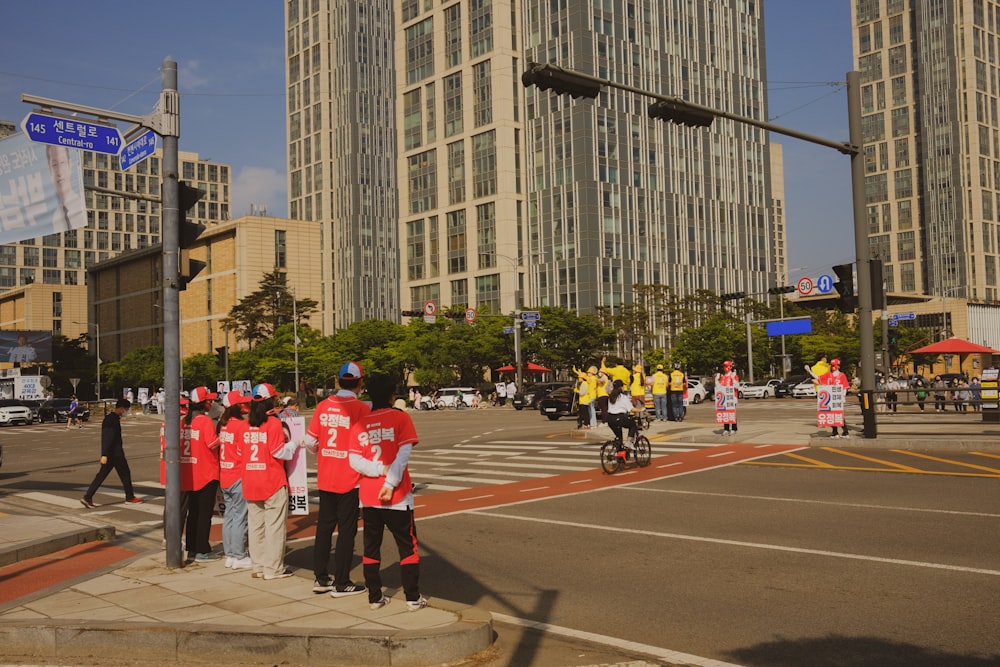 a group of people standing on the side of a road