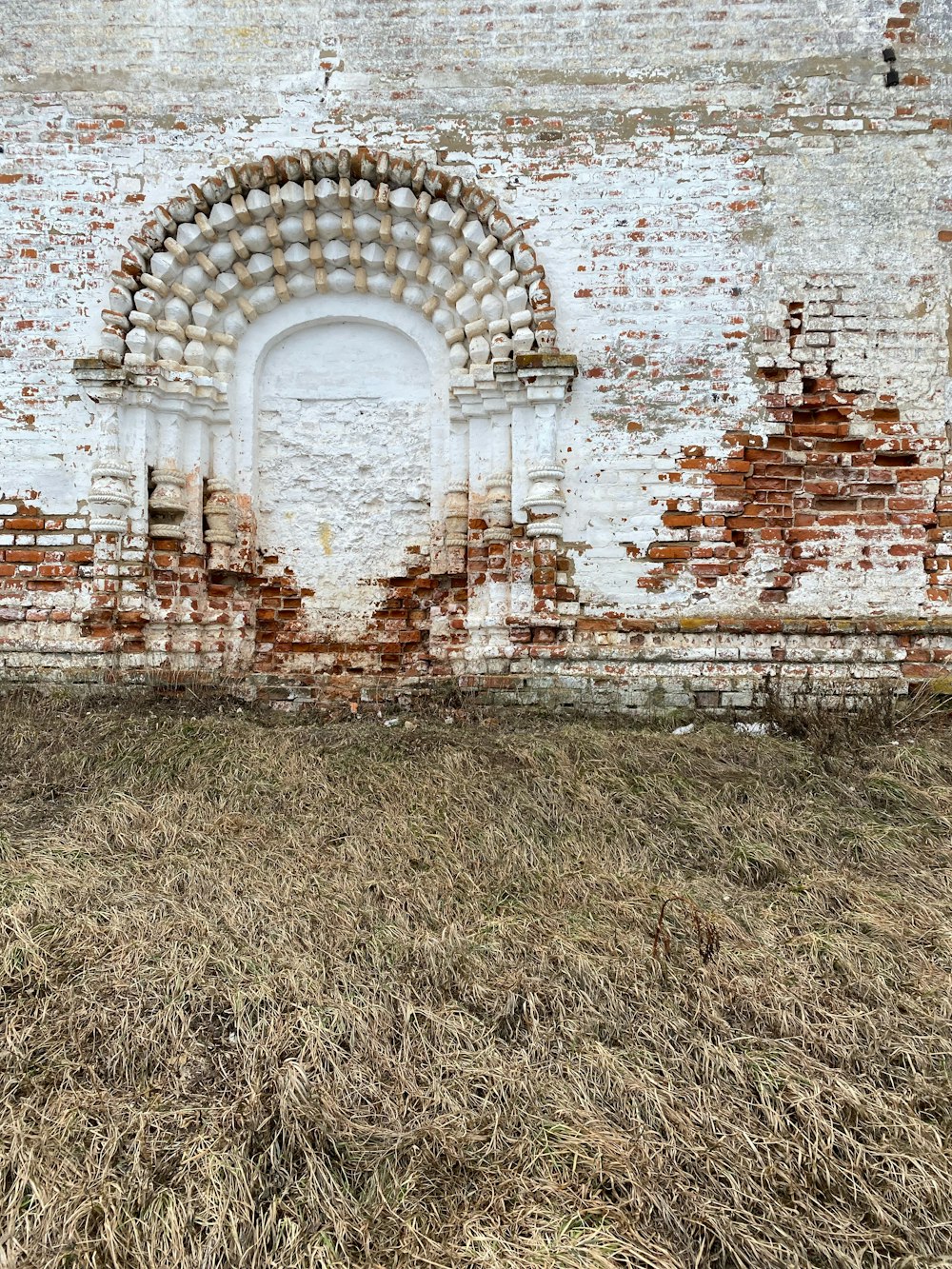 an old brick building with a white door and window