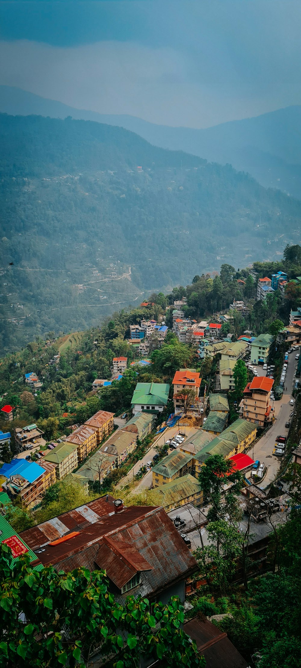 a view of a small town in the mountains