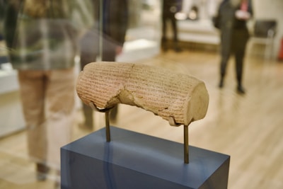 Ancient Sumerian clay seal with cuneiform inscriptions and symbolic imagery.