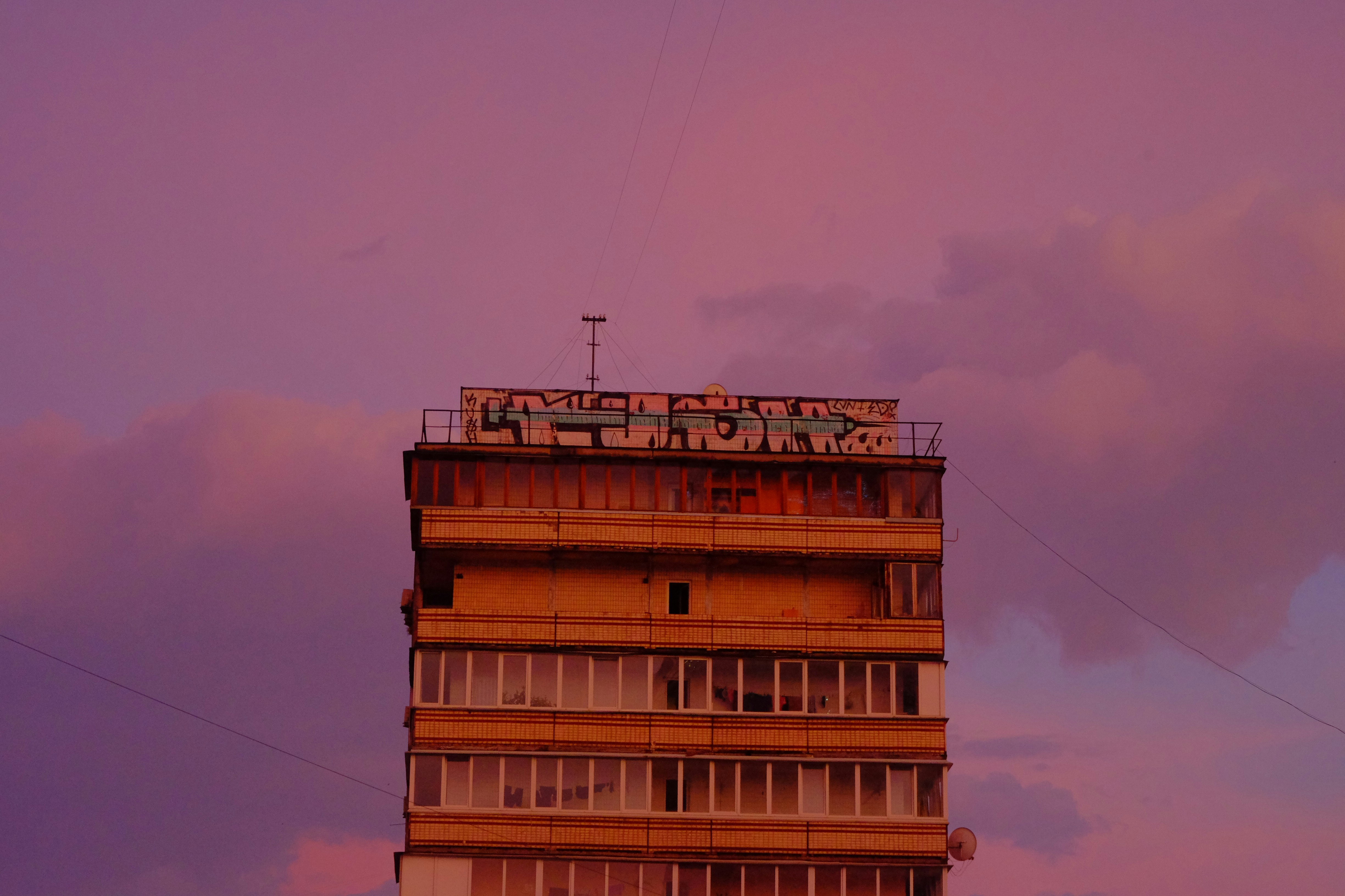 a tall building with a sign on top of it