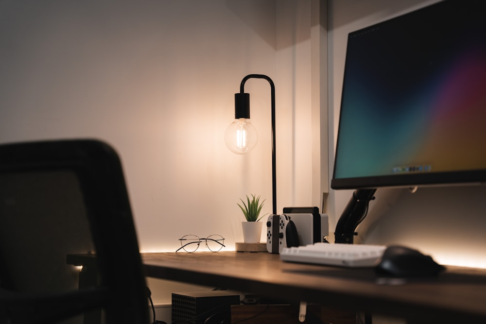 a computer monitor sitting on top of a wooden desk