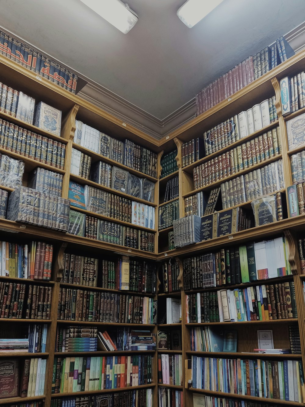 a bookshelf filled with lots of books in a library