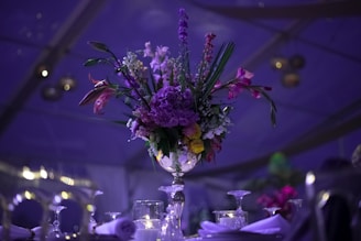 a vase filled with purple flowers on top of a table
