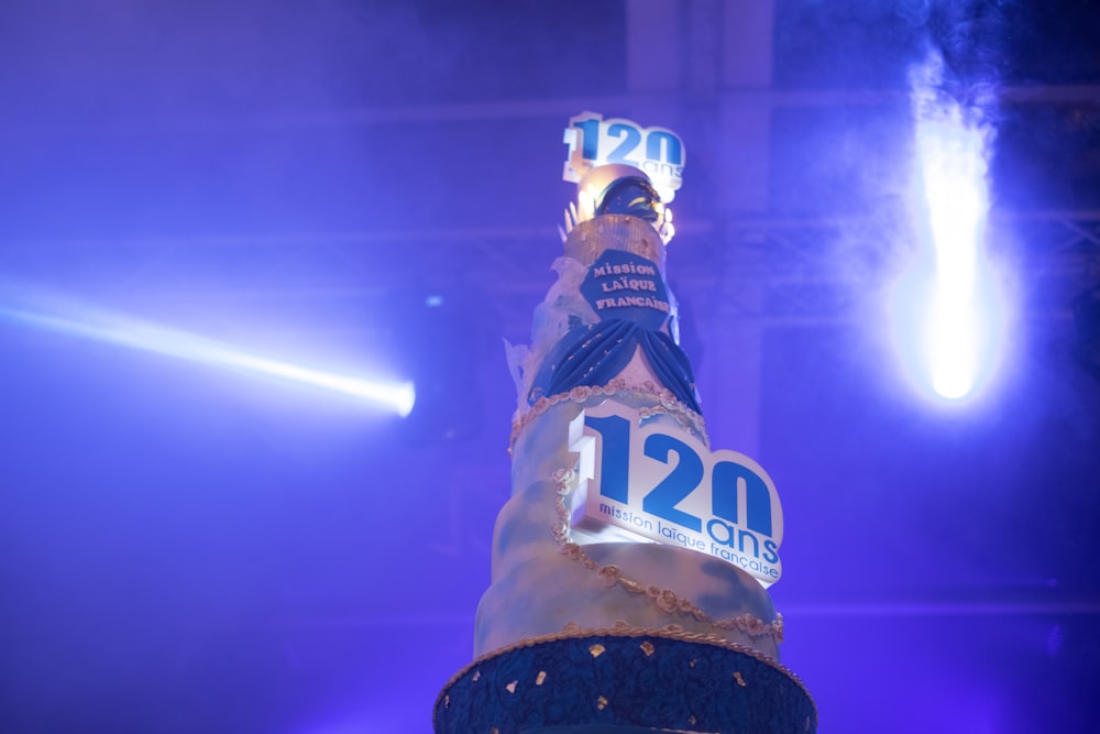 a large bottle of beer sitting on top of a stage