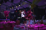 a table set up for a party with candles and flowers