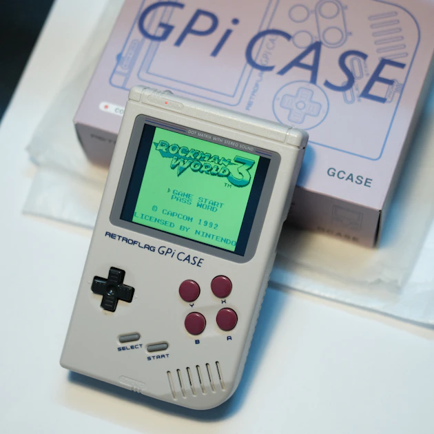 The TrimUI Brick Pro handheld with dual analog sticks running a 3D platformer