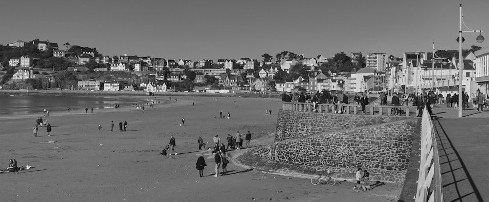 a group of people standing on top of a sandy beach