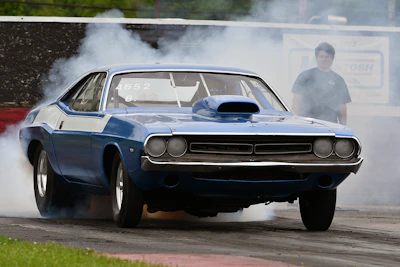 a blue car with smoke coming out of it
