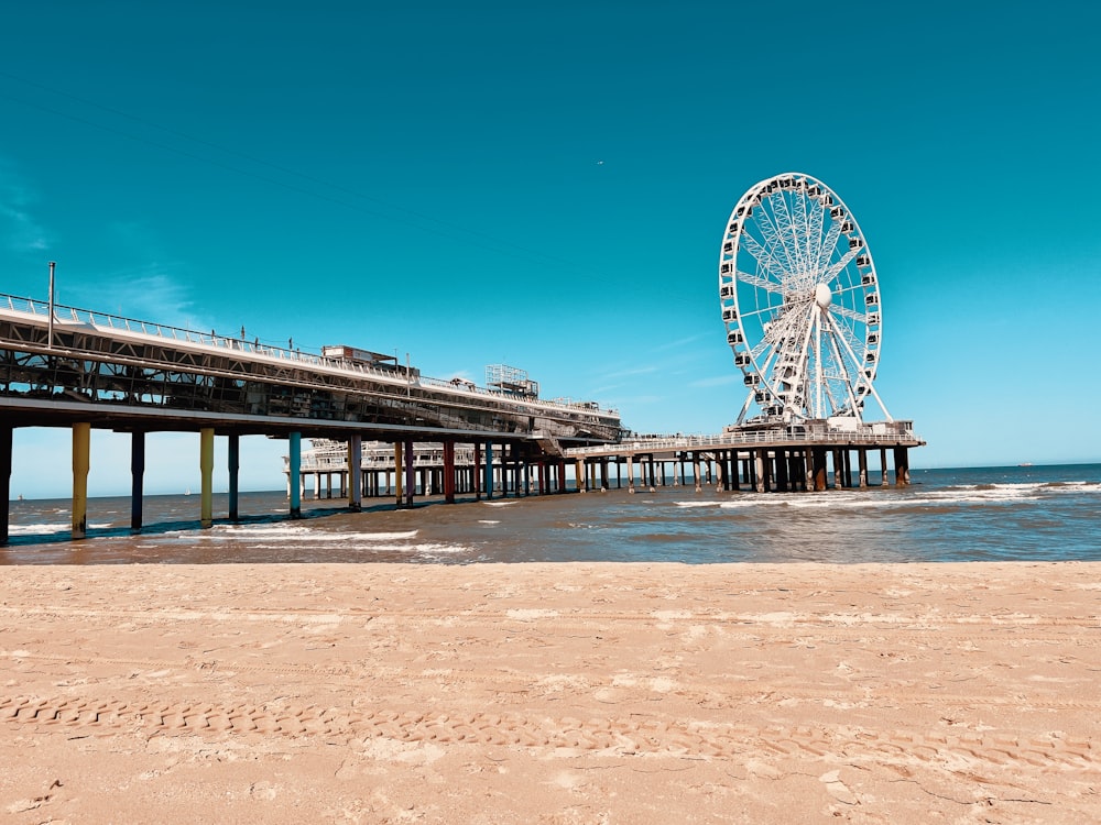 a ferris wheel sitting on top of a sandy beach