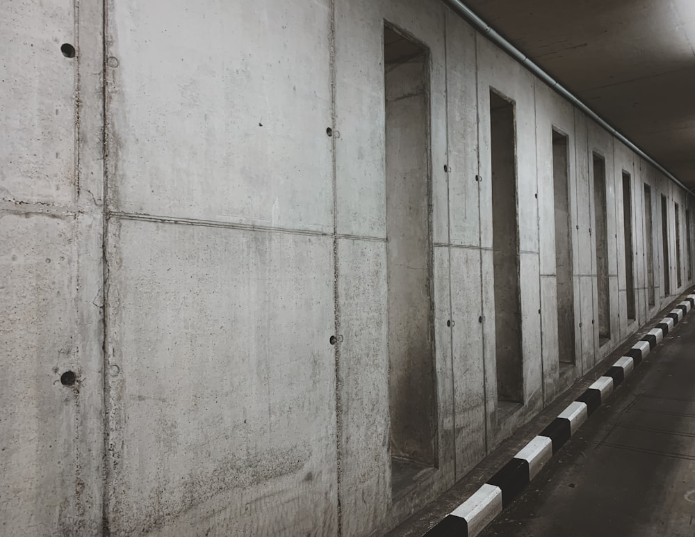 a row of concrete walls in a parking garage