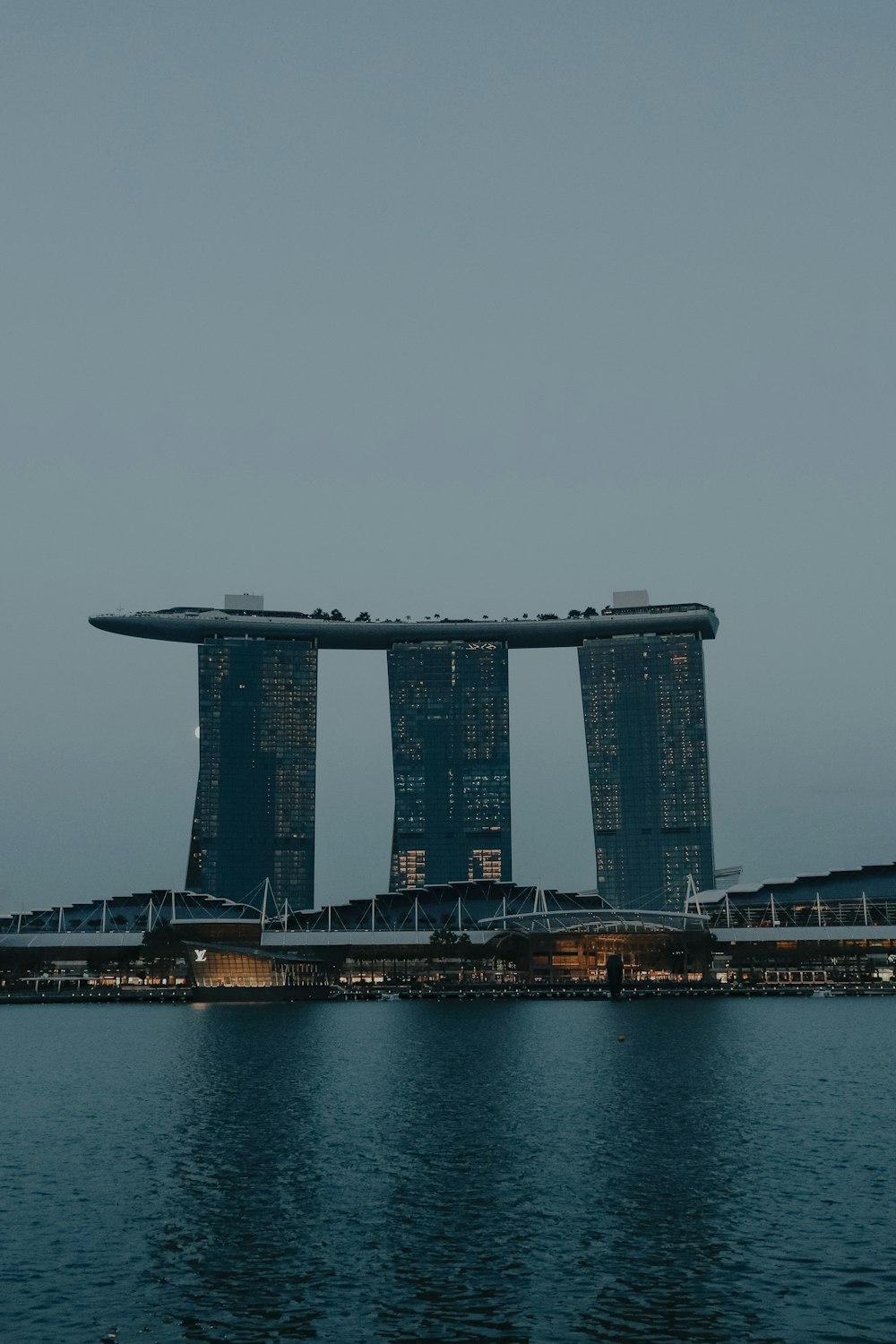 a large body of water next to a tall building