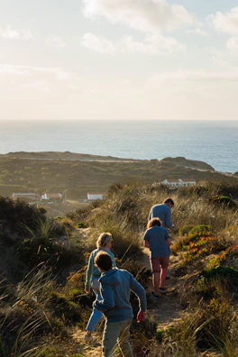 Tourists enjoying a guided walk through the dunes with local guides pointing out natural wonders.