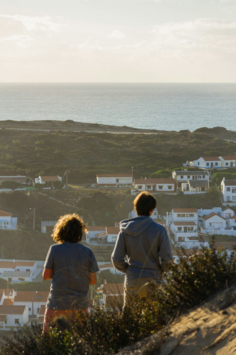 a couple of people that are standing on a hill