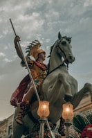 a man riding on the back of a white horse