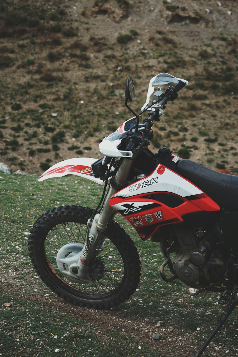 a dirt bike parked on top of a grass covered field