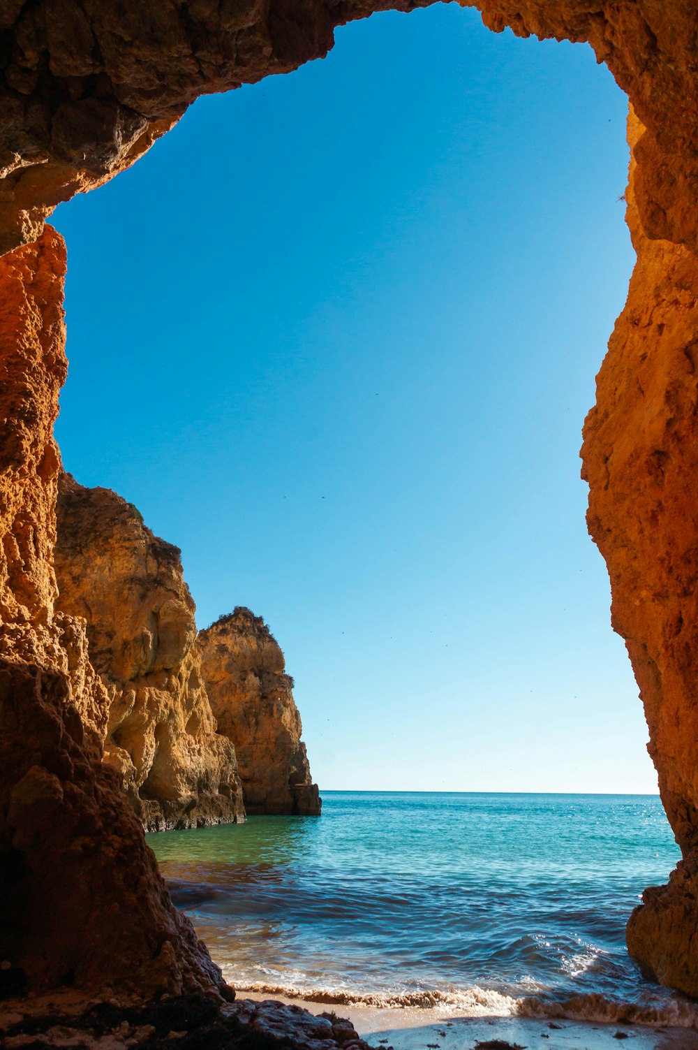 a view of the ocean from inside a cave