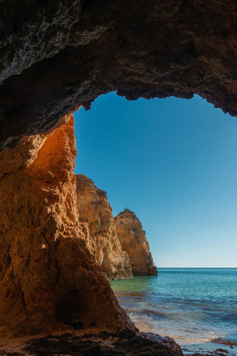 a view of the ocean from inside a cave