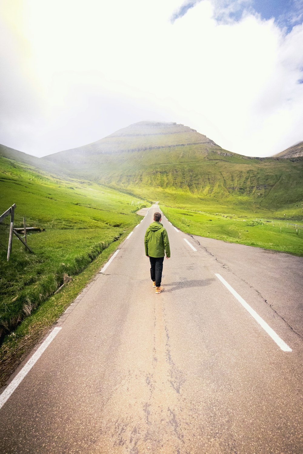 a person walking down the middle of a road