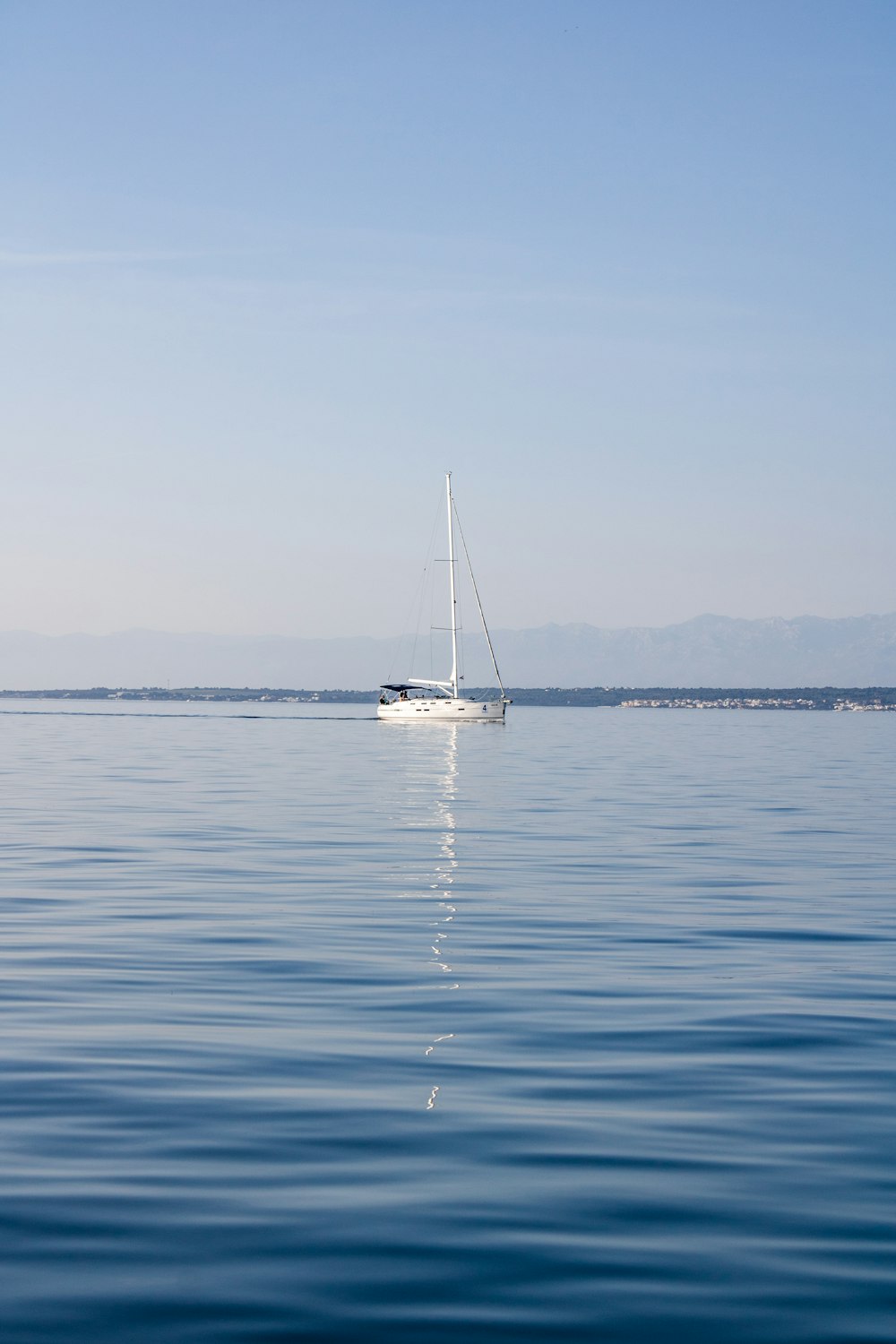 a sailboat floating in the middle of a large body of water