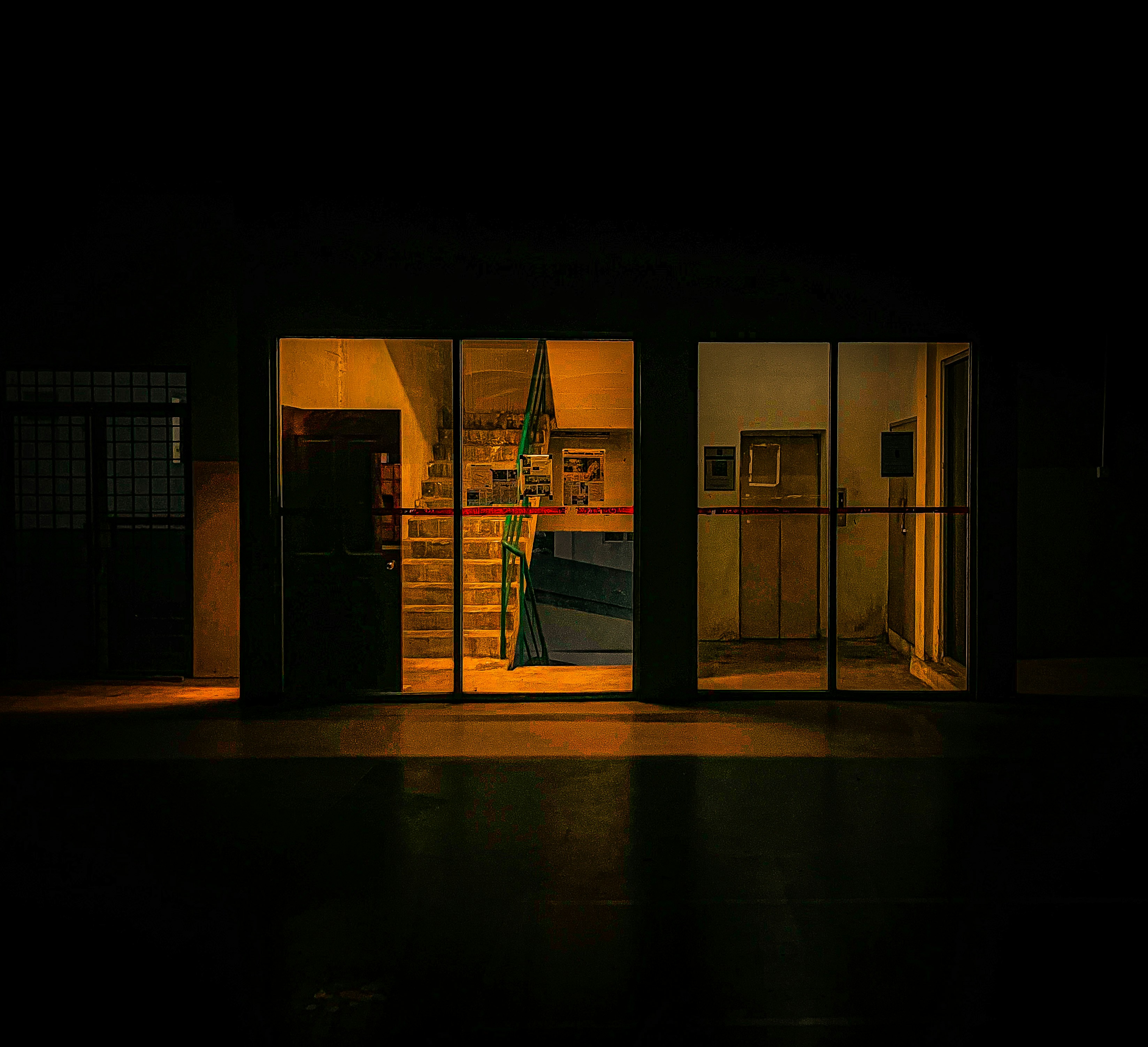 a dark room with two open doors at night