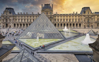 a pyramid shaped building with a fountain in front of it