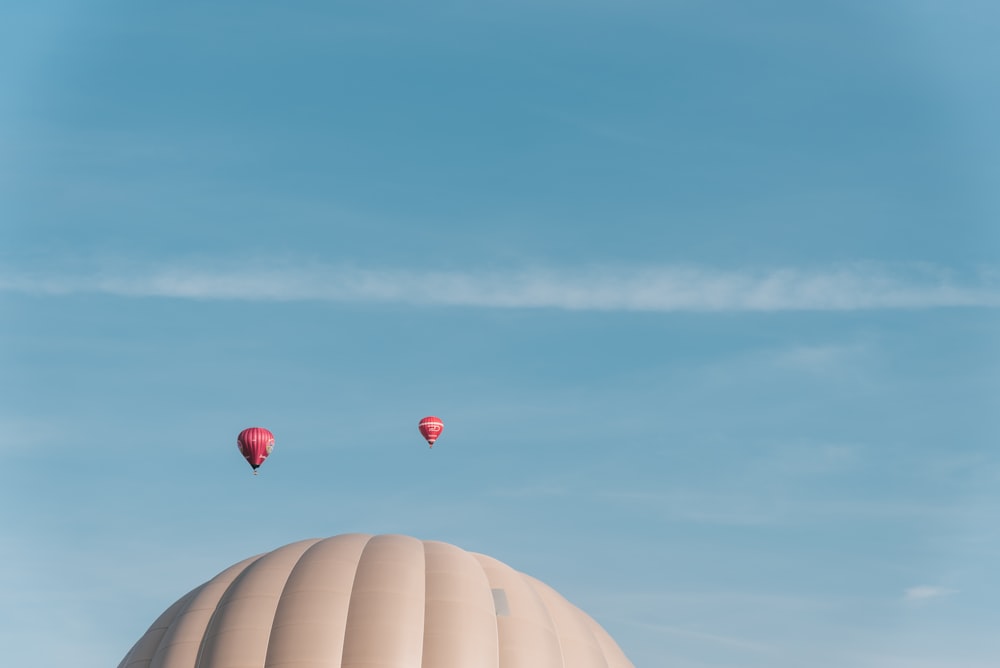 two hot air balloons are flying in the sky