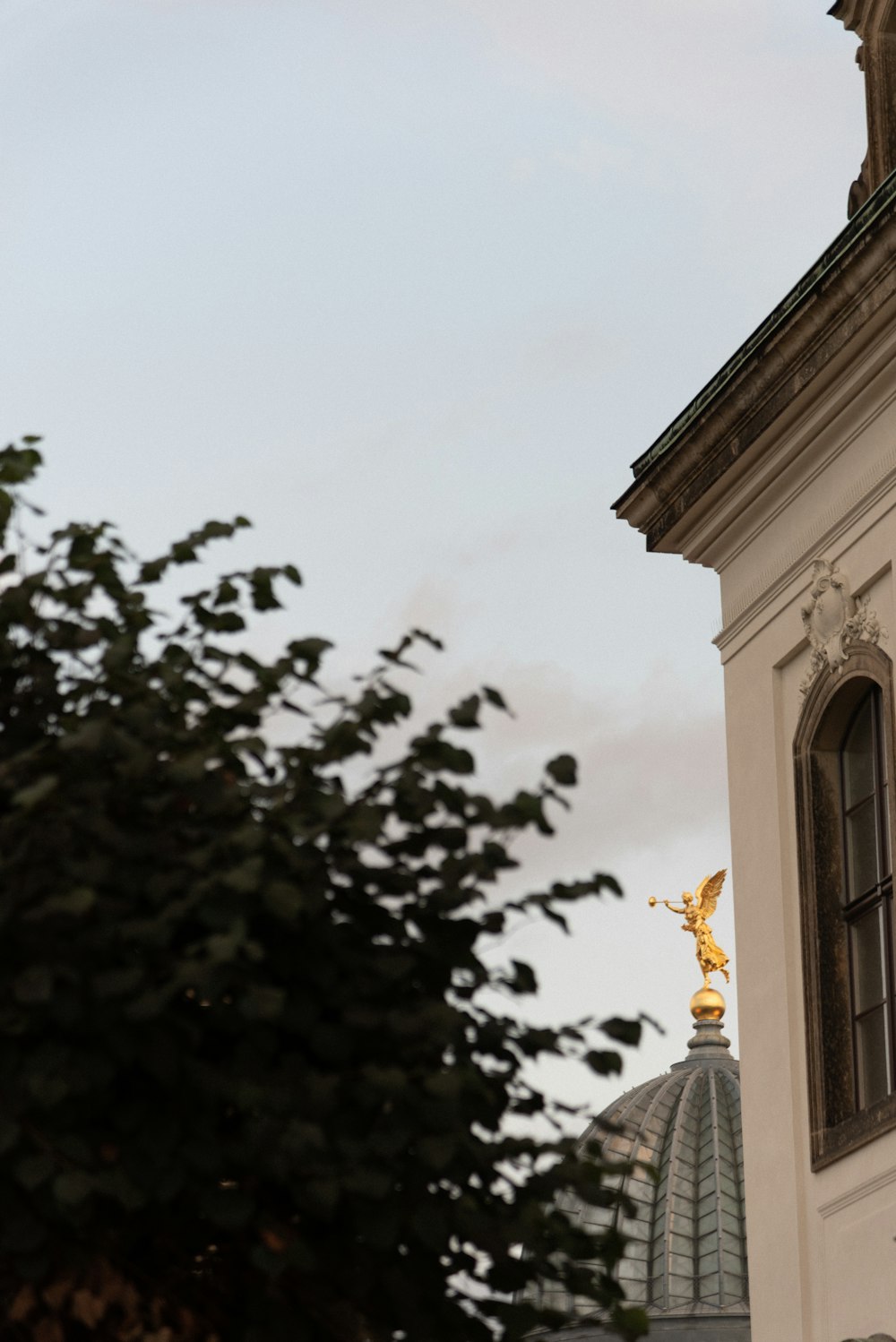 a clock tower with a statue on top of it