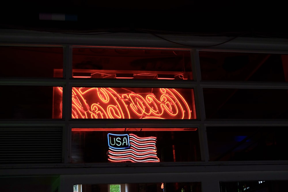 a coca cola sign lit up in the dark