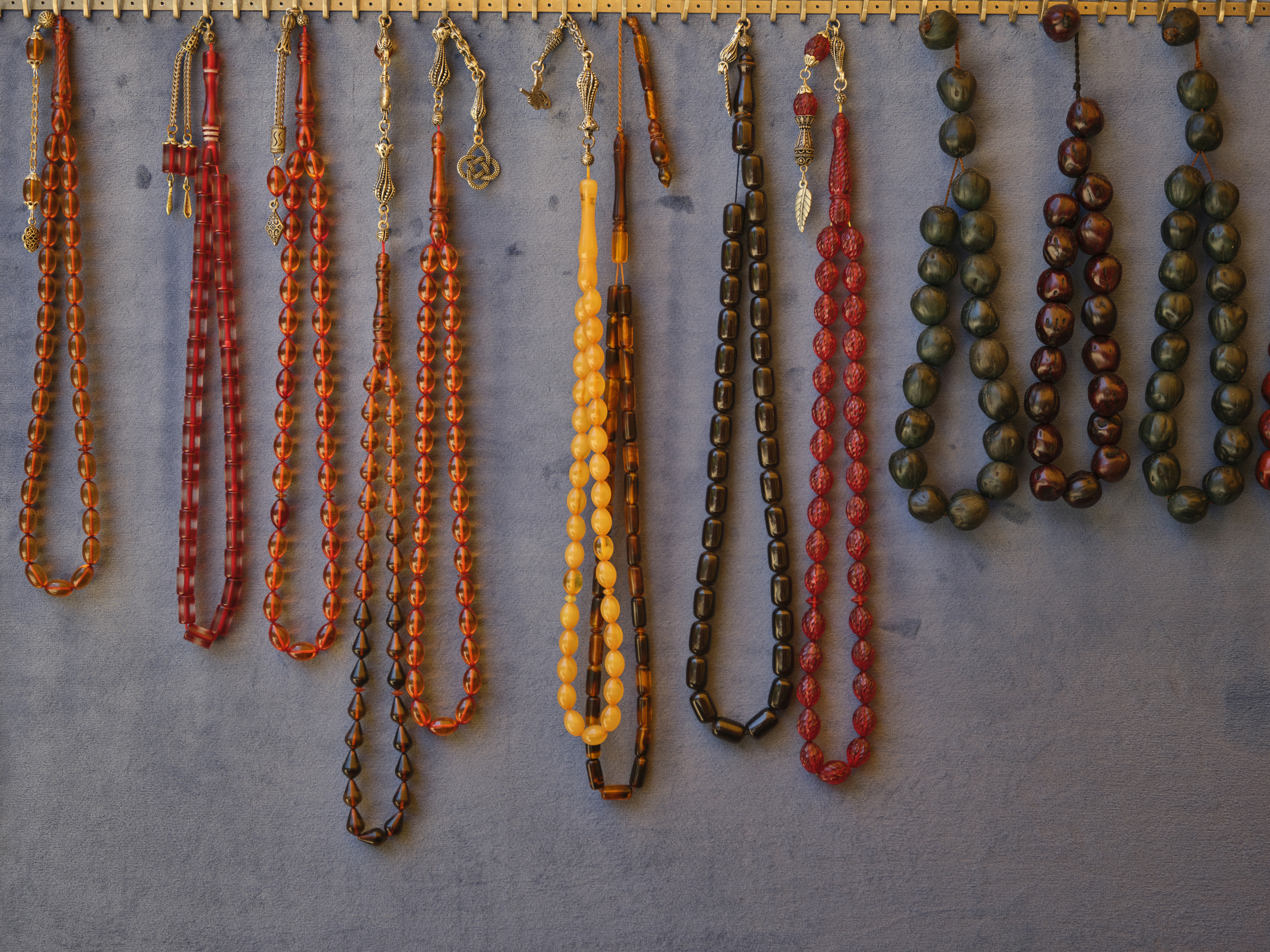 a number of necklaces hanging on a wall