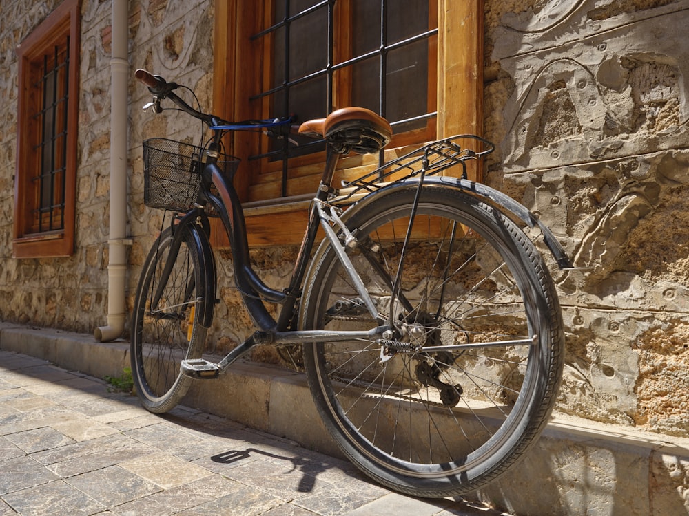 a bicycle parked next to a stone building
