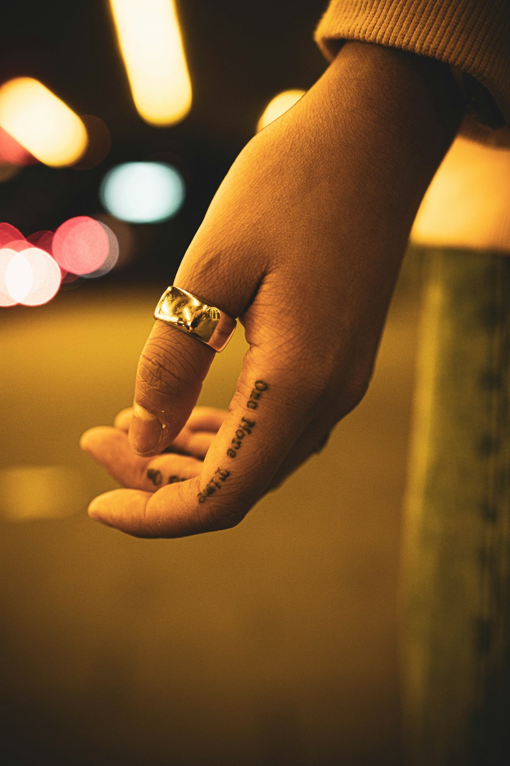 a person's hand with a ring on it