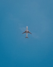 a large jetliner flying through a blue sky