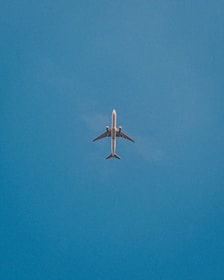 a large jetliner flying through a blue sky