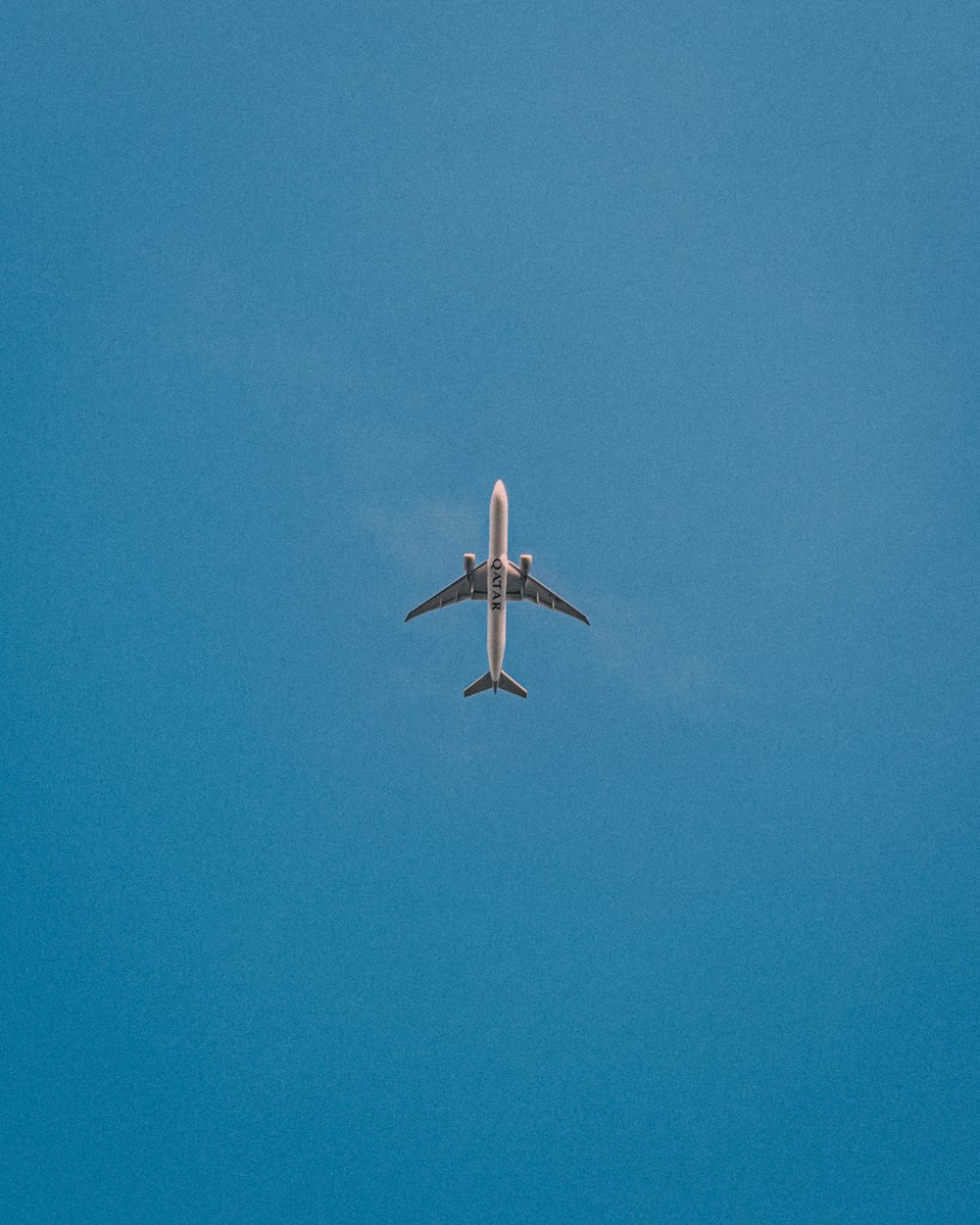 a large jetliner flying through a blue sky