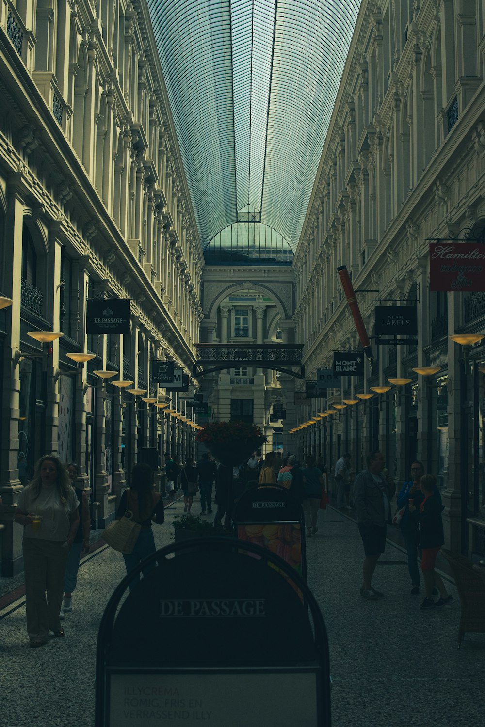 a view of a street with people walking down it