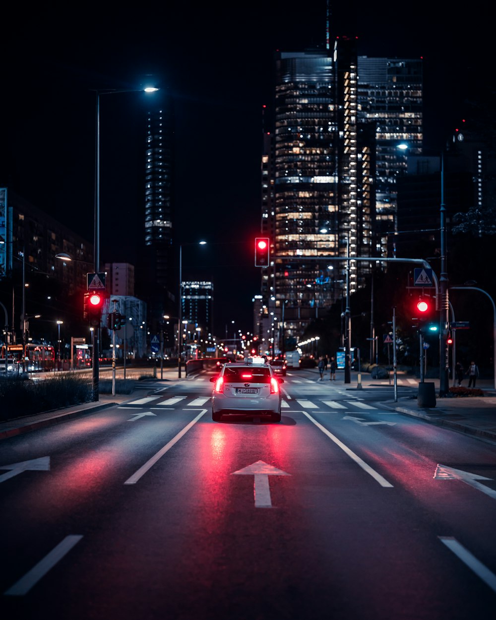 a car driving down a city street at night