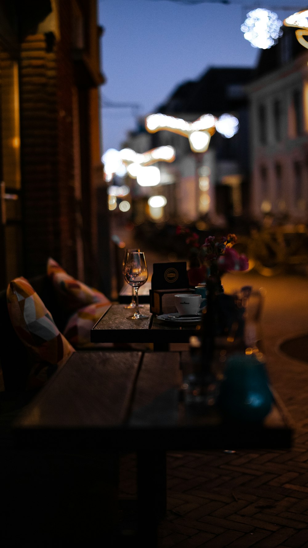 a glass of wine sitting on top of a wooden table