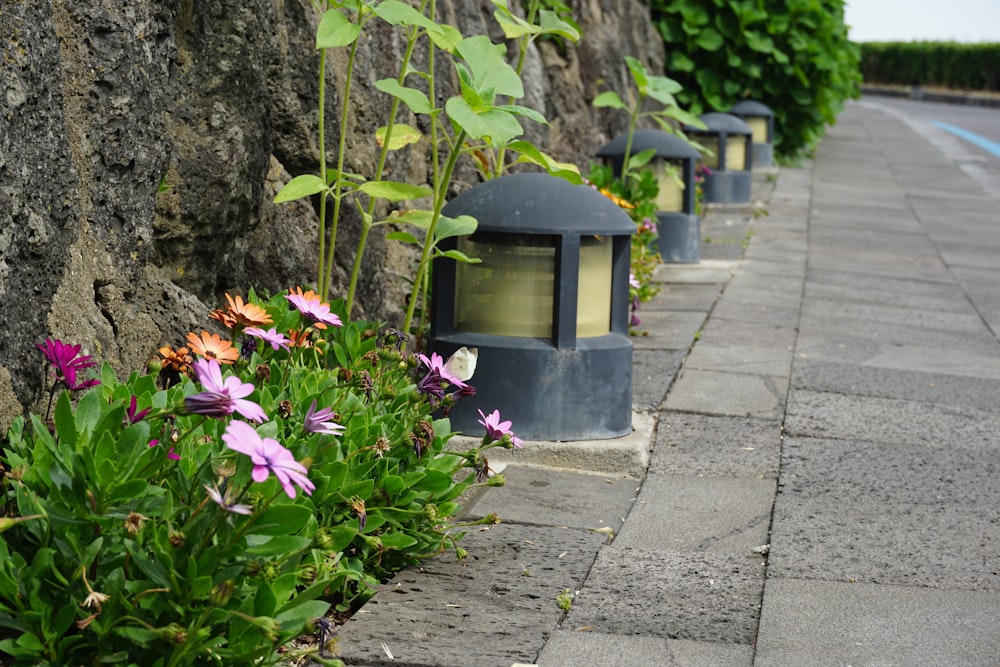 a row of lights sitting next to a stone wall