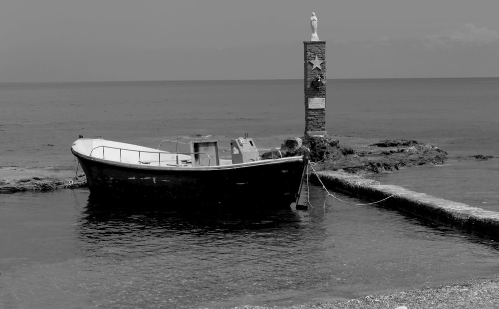 a black and white photo of a boat in the water