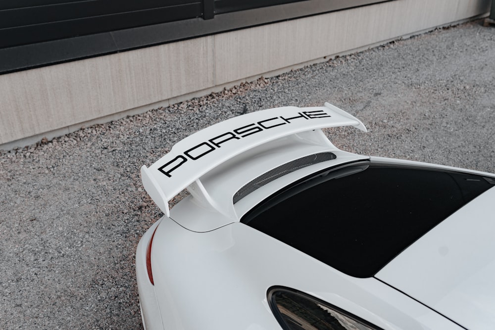a white sports car parked in front of a building