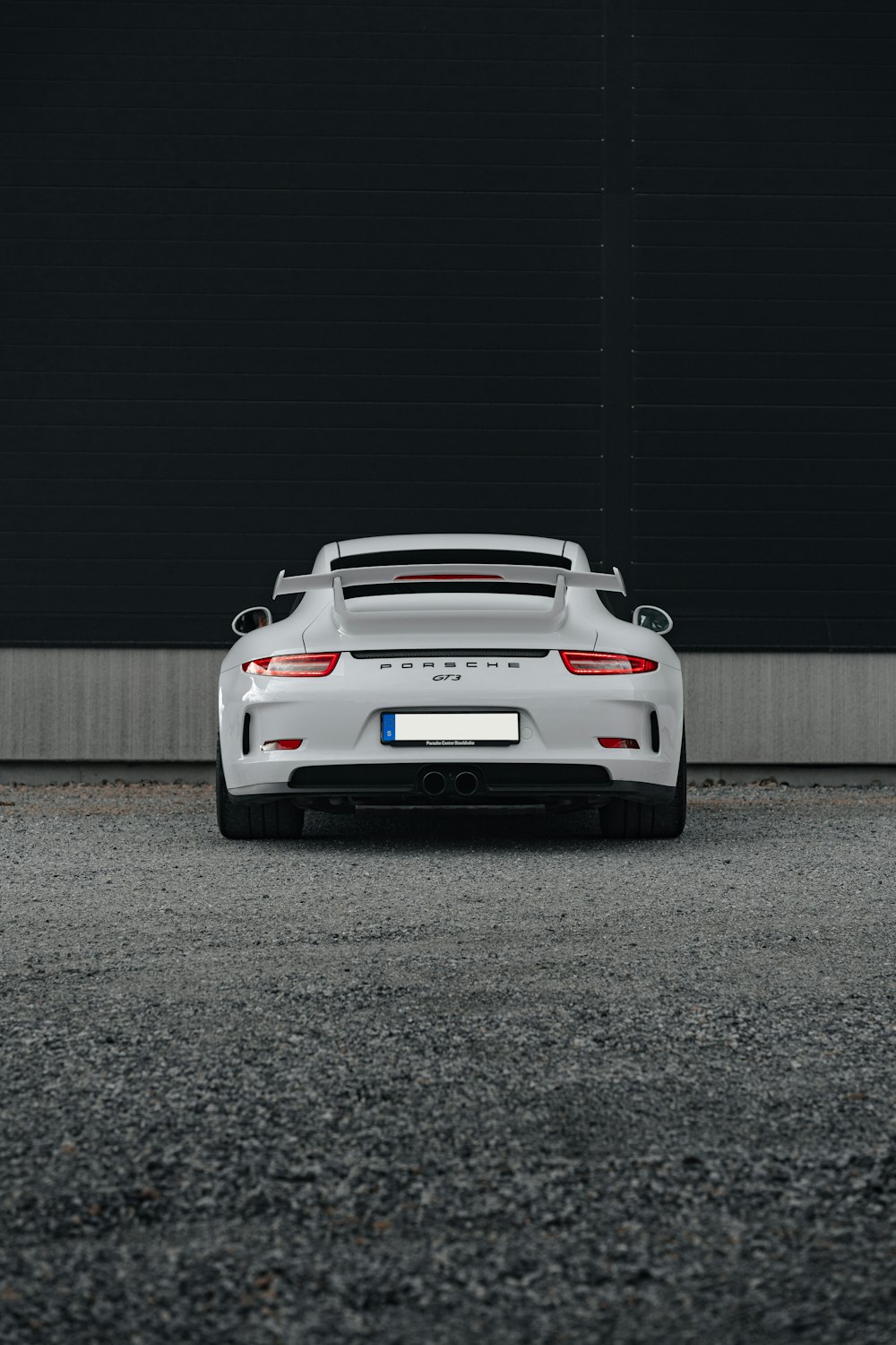 a white sports car parked in a parking lot