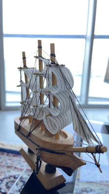 A detailed marine vessel model resting on a polished wooden shelf inside the vault.