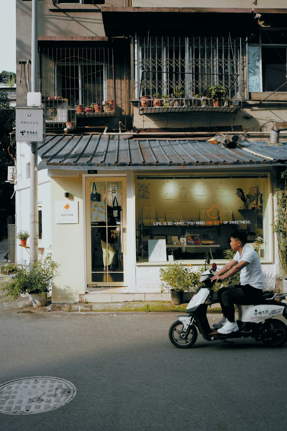 a man riding a motorcycle down a street