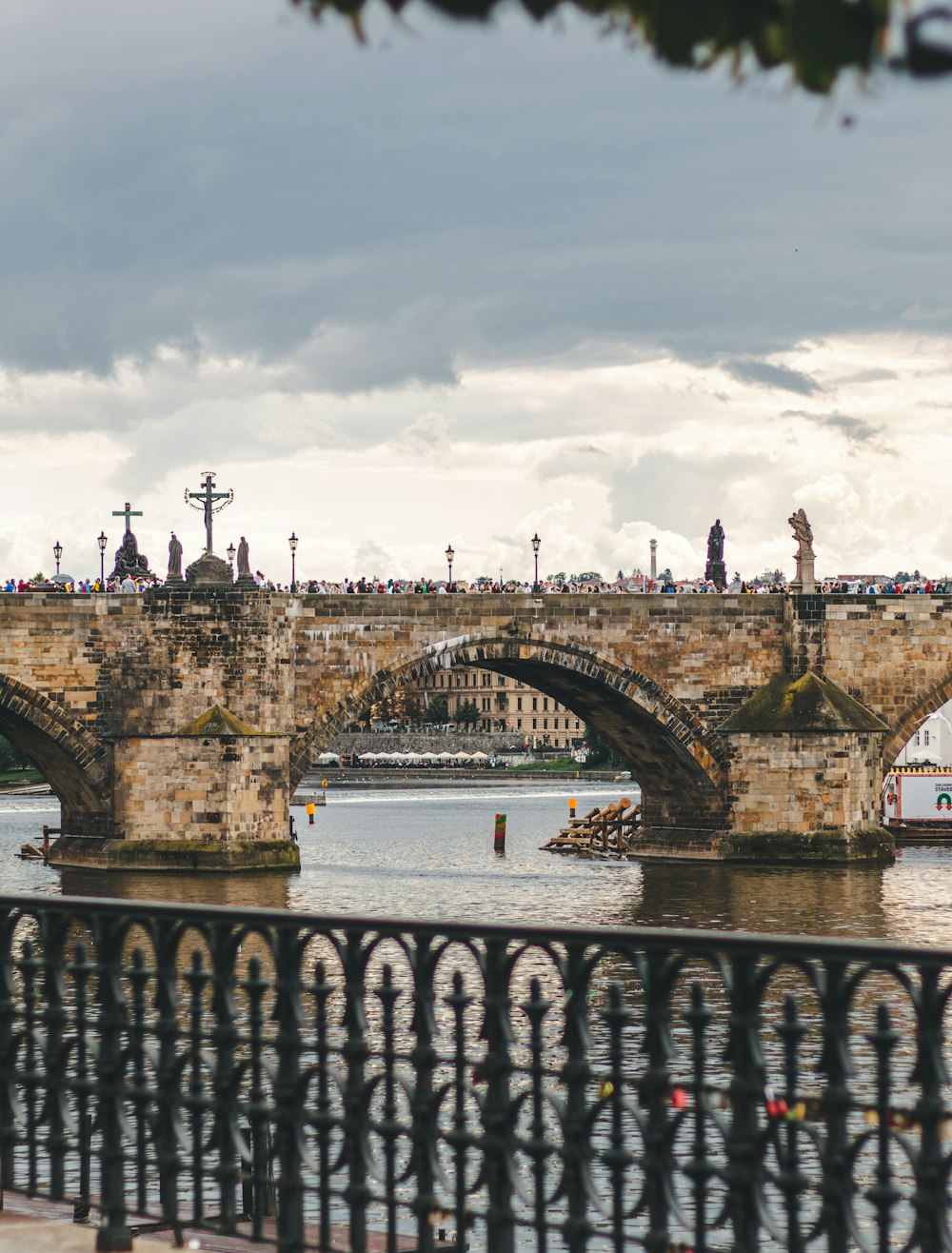 a bridge over a body of water with a building in the background