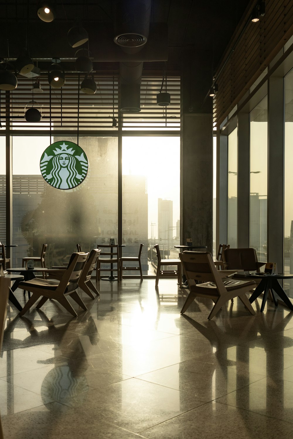 a starbucks sign hanging from the side of a building